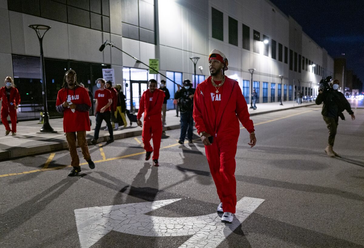 Workers march in a parking lot