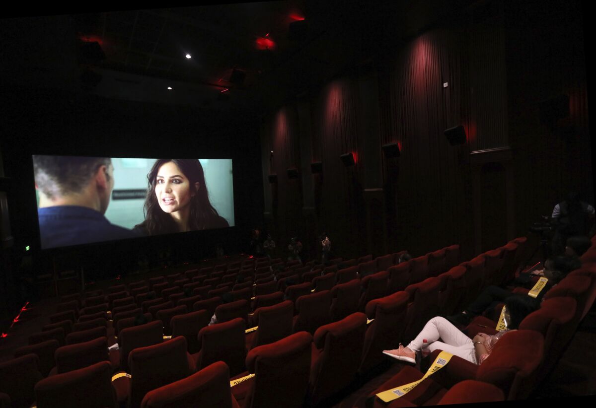 Moviegoers watch a Bollywood film in New Delhi, India, after cinemas reopened in much of the country in October.