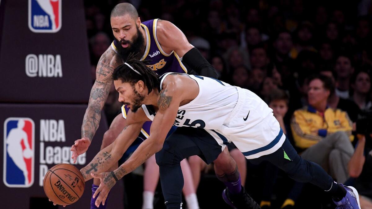 Minnesota's Derrick Rose regains control of the ball in front of the Lakers' Tyson Chandler.