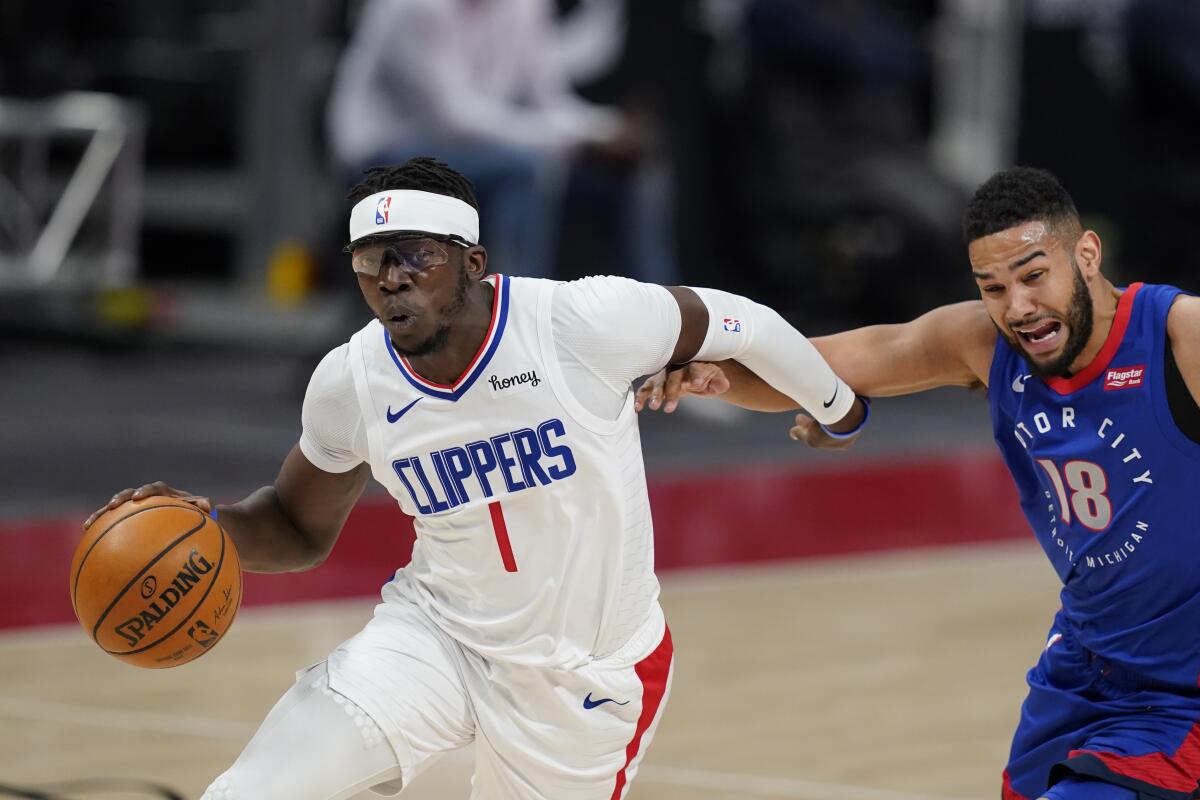 Clippers guard Reggie Jackson drives around Detroit Pistons guard Cory Joseph.