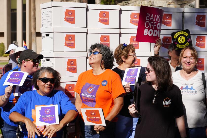 FILE - Arizona abortion-rights supporters gather for a news conference prior to delivering more than 800,000 petition signatures to the state Capitol to get abortion rights on the November general election ballot, July 3, 2024, in Phoenix. (AP Photo/Ross D. Franklin, File)