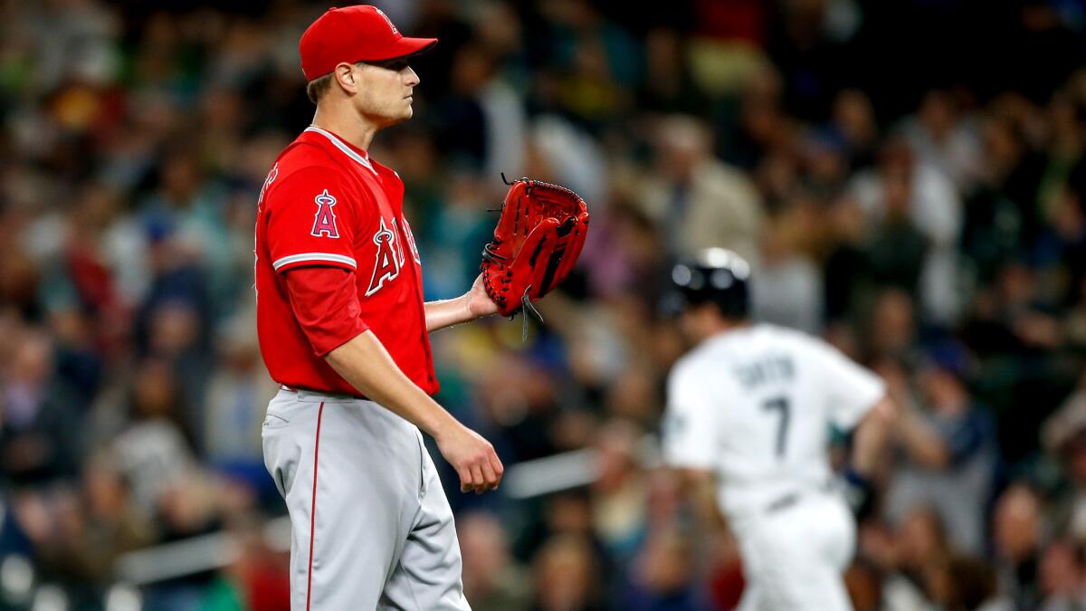Angels starter Garrett Richards waits for a new ball after giving up a two-run homer to Seth Smith in the second inning Monday night in Seattle.