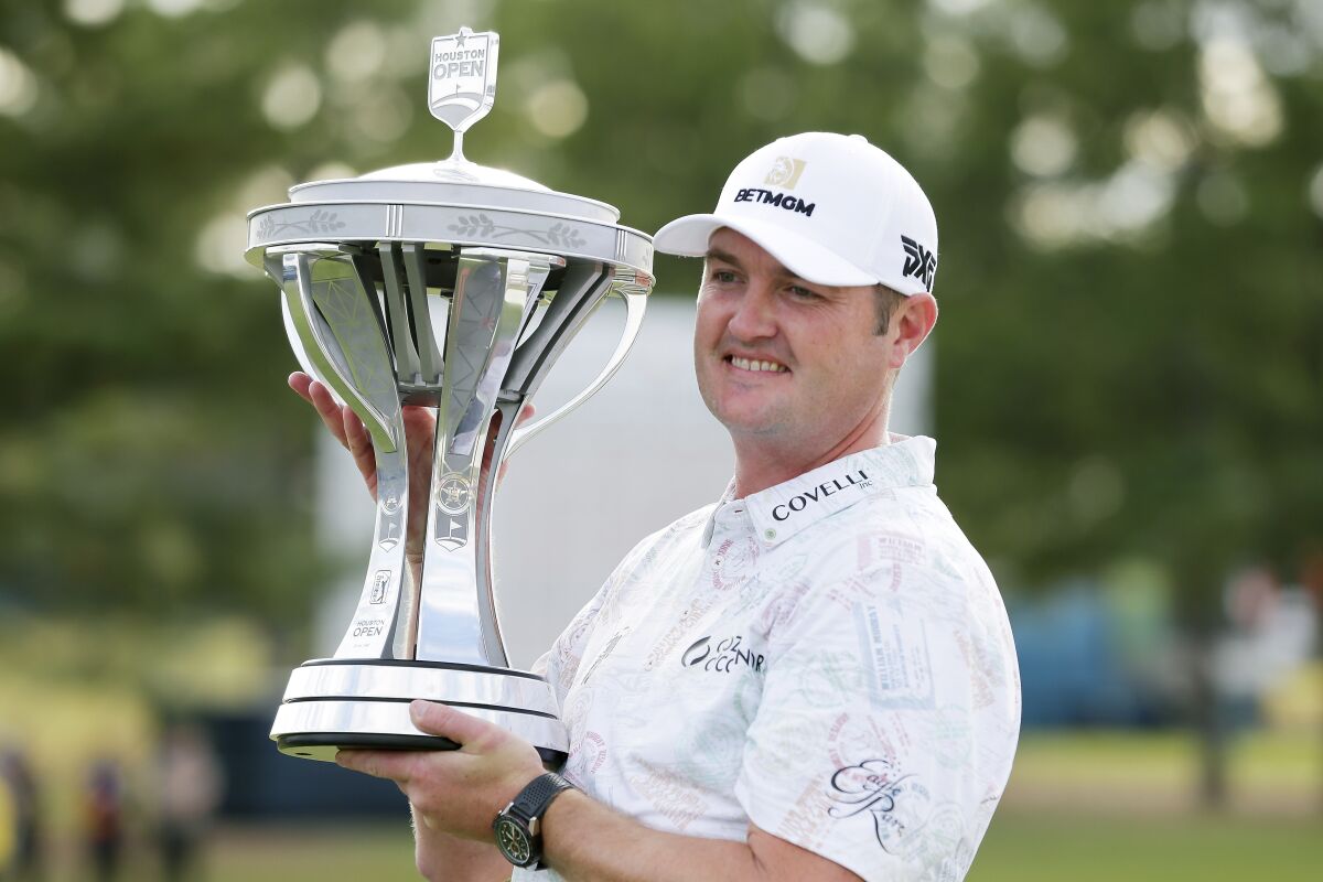 Tournament winner Jason Kokrak holds the trophy during presentation ceremonies after the final round of the Houston Open golf tournament Sunday, Nov. 14, 2021, in Houston. (AP Photo/Michael Wyke)