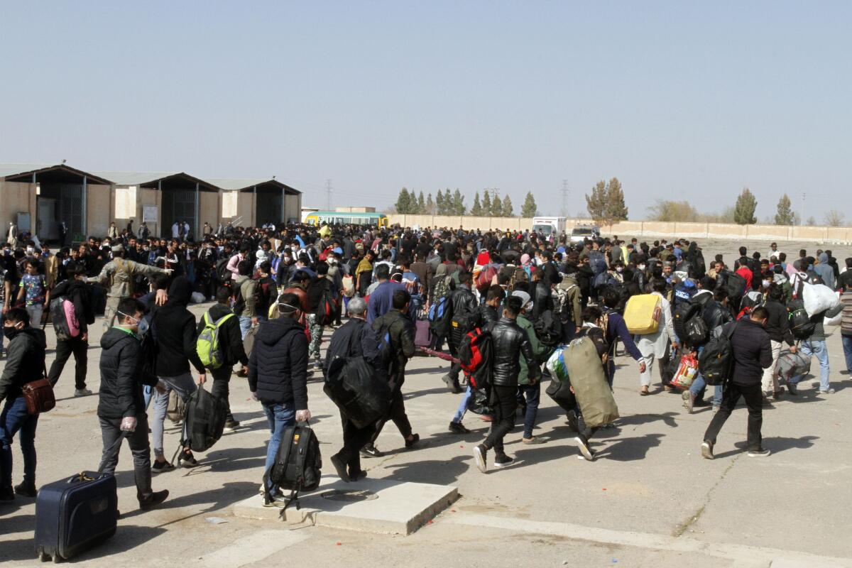 Thousands of Afghan refugees enter Afghanistan's Herat province via Iran on March 18.