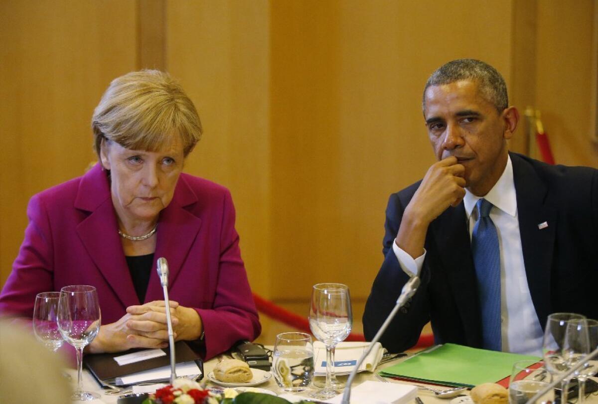 President Obama is seen with German Chancellor Angela Merkel at a G-7 working dinner in Brussels on June 4.