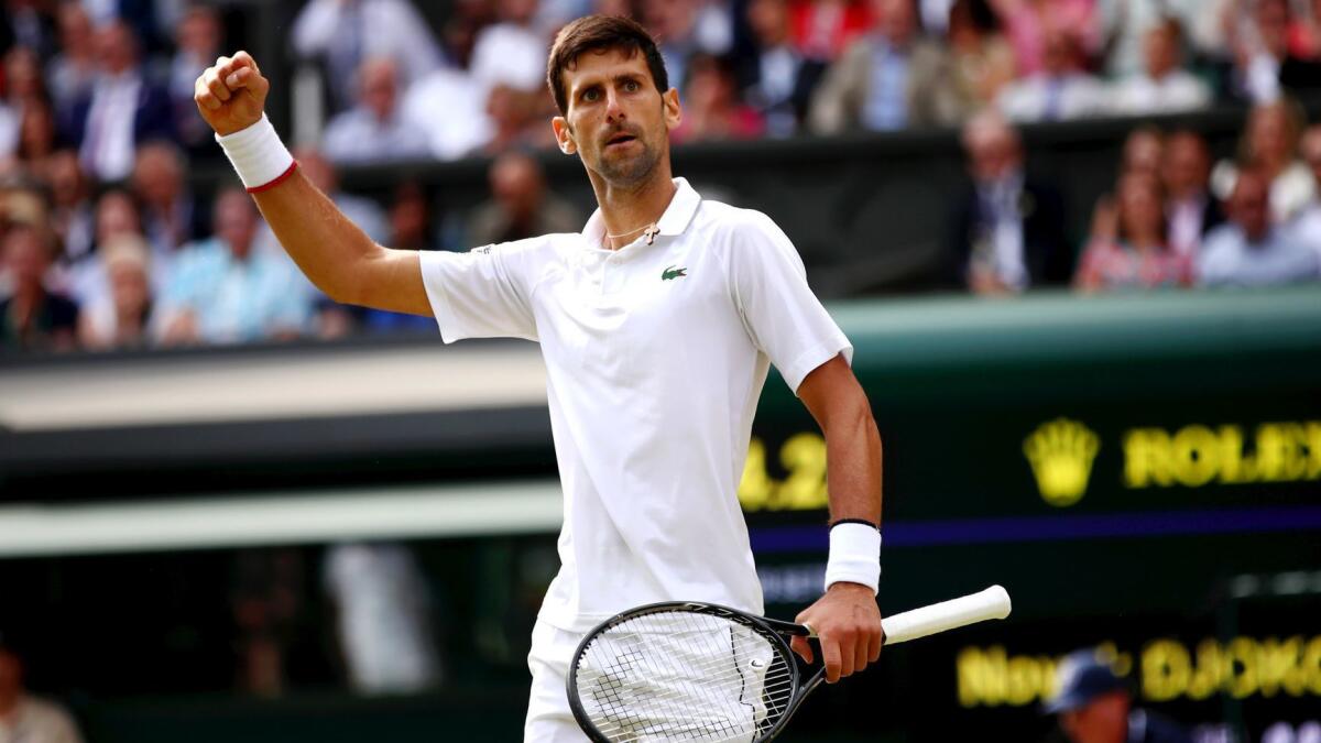 Novak Djokovic celebrates after winning a point against Roger Federer in the Wimbledon men's singles final Sunday.