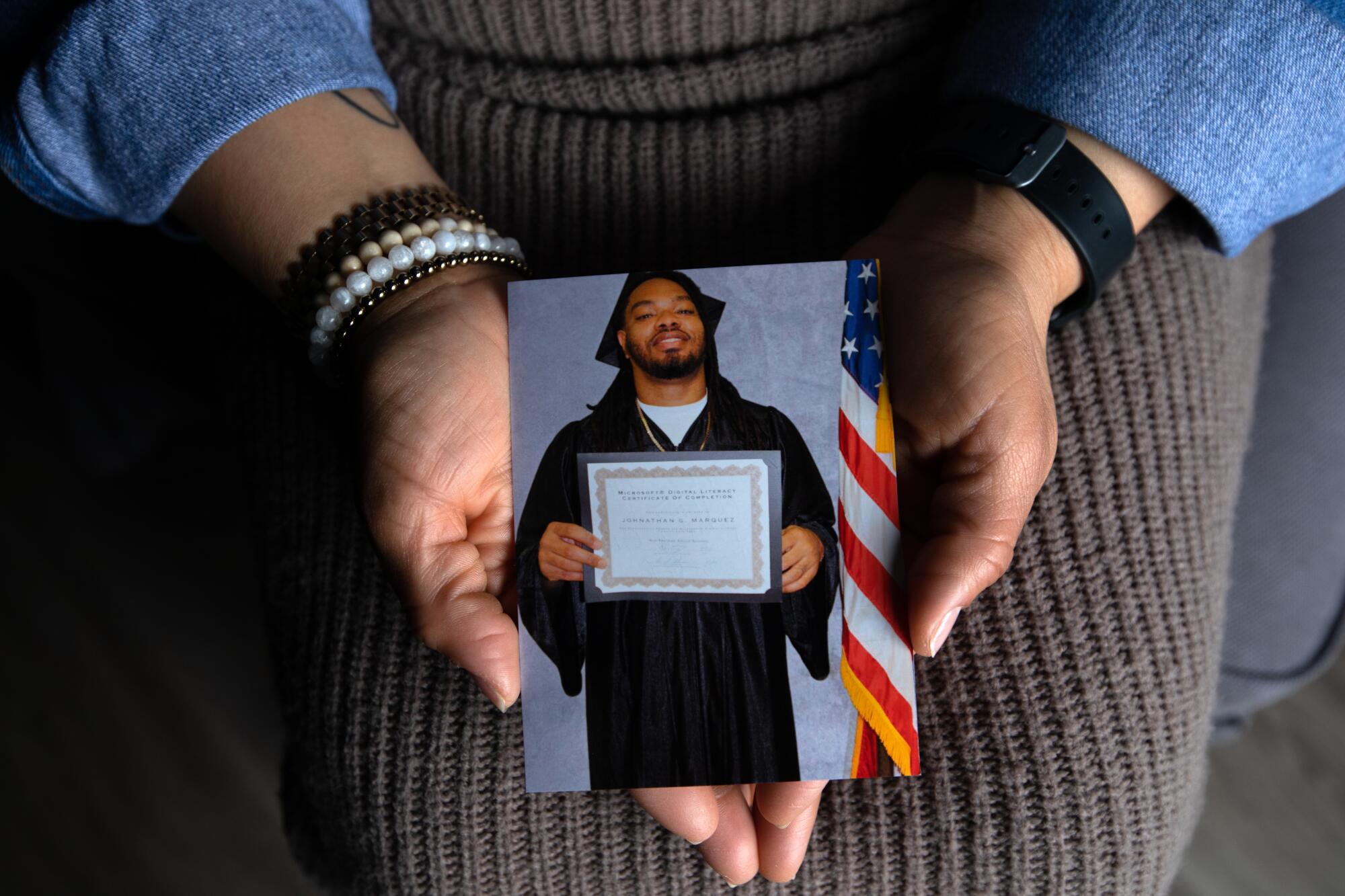 A close-up of a woman holding a photo of a man