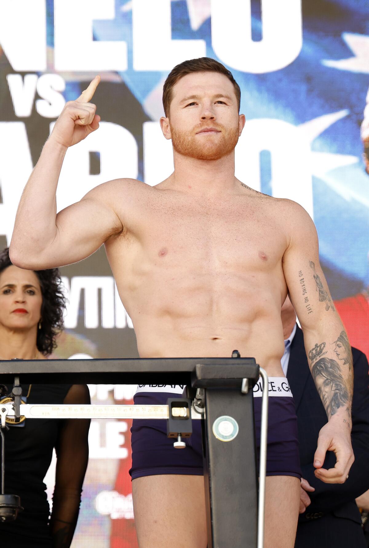Undisputed super middleweight champion Saul “Canelo” Alvarez poses on a scale during a ceremonial weigh-in in Las Vegas