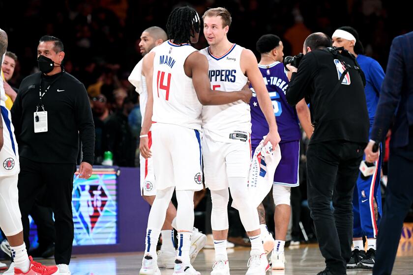 LOS ANGELES-CA-FEBRUARY 25, 2022: Los Angeles Clippers' Terance Mann, left, and Luke Kennard celebrate a win against the Lakers at Crypto.com Arena in downtown Los Angeles on Friday, February 25, 2022. (Christina House / Los Angeles Times)