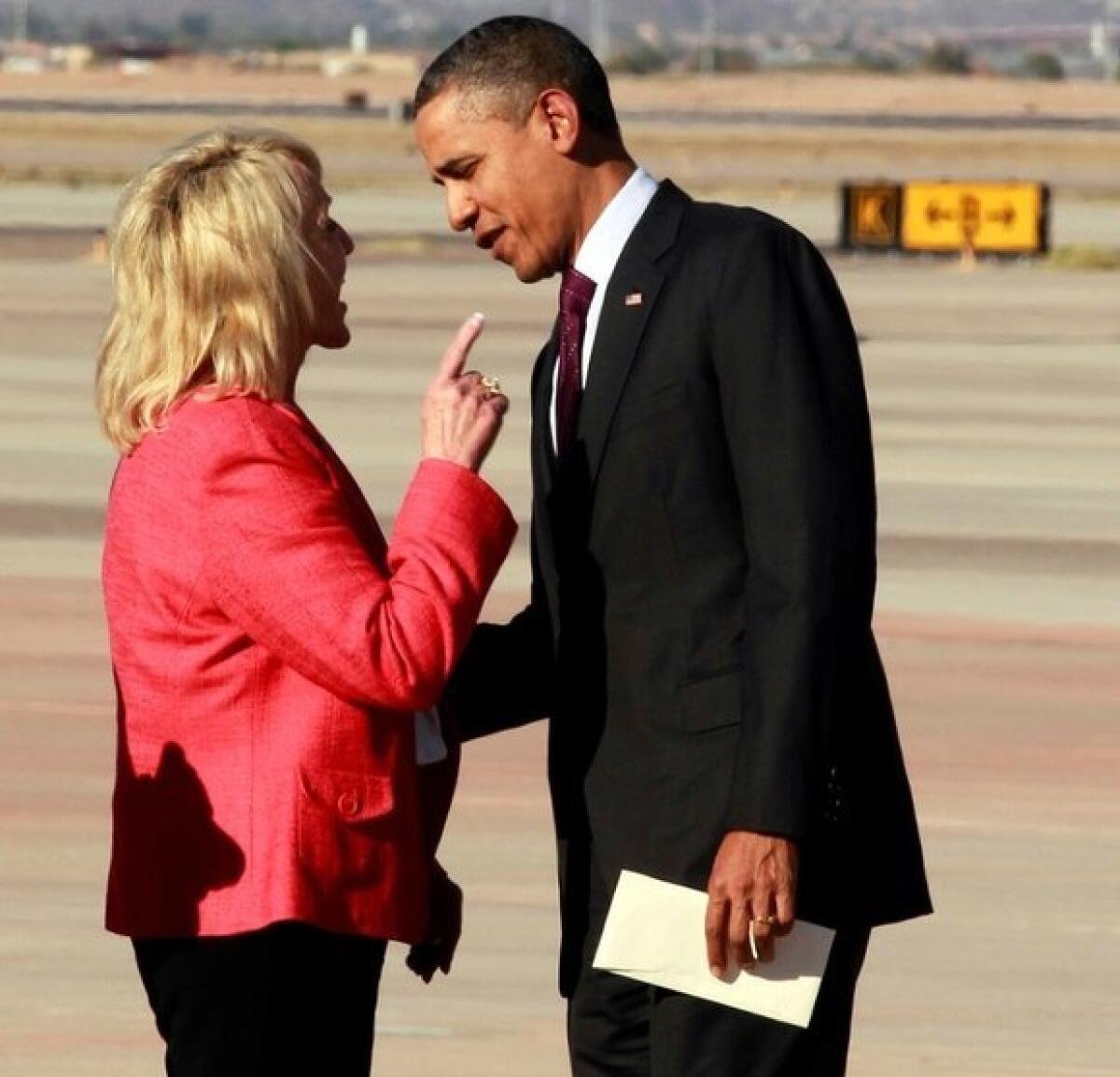 Arizona Gov. Jan Brewer and President Obama in an animated exchange at the airport in Phoenix.