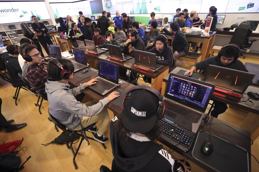 The Westview High School team, left, and the Otay Ranch High School team get ready to compete during the first ever San Diego County Office of Education's League of Legends esports tournament at the Microsoft Store at the Fashion Valley mall on Friday, November 22, 2019 in San Diego, California.