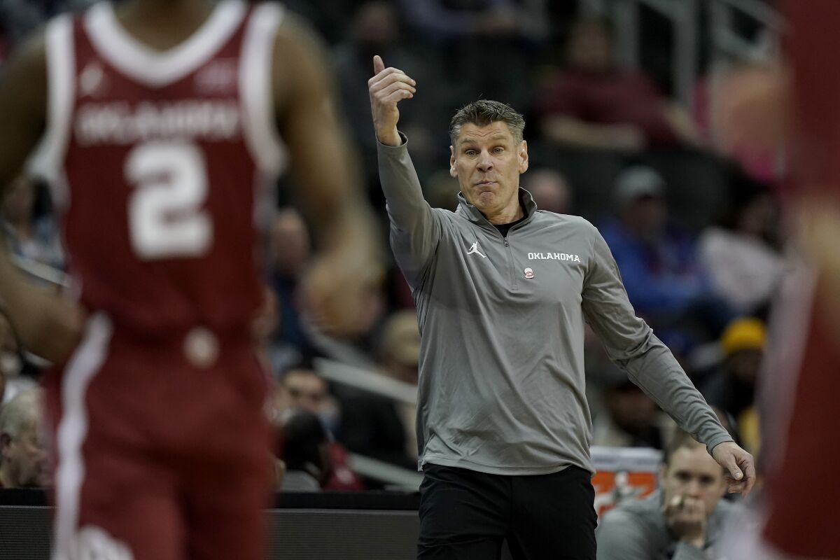 Oklahoma head coach Porter Moser motions to his players during the first half of an NCAA college basketball game against Baylor in the quarterfinal round of the Big 12 Conference tournament in Kansas City, Mo., Thursday, March 10, 2022. (AP Photo/Charlie Riedel)