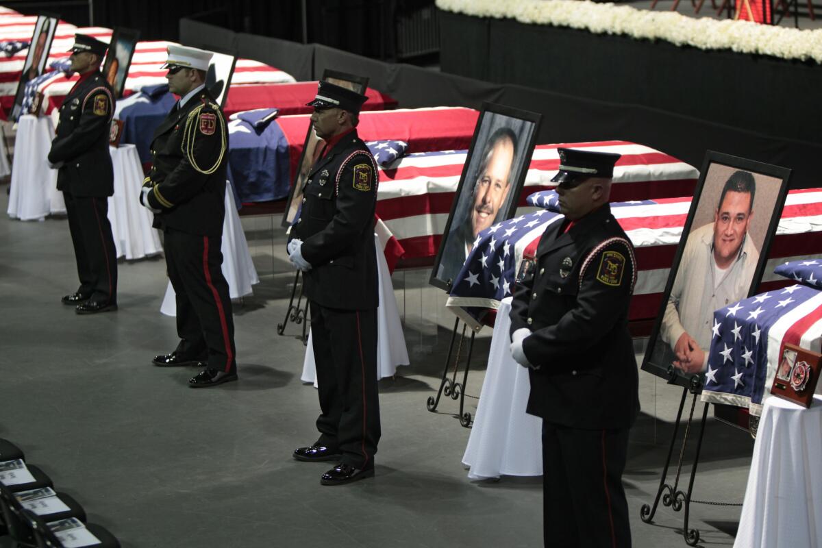 Honor guards stand at caskets at a memorial service for those killed in the West, Texas, fertilizer plant explosion. Most of those killed were volunteer first-responders.