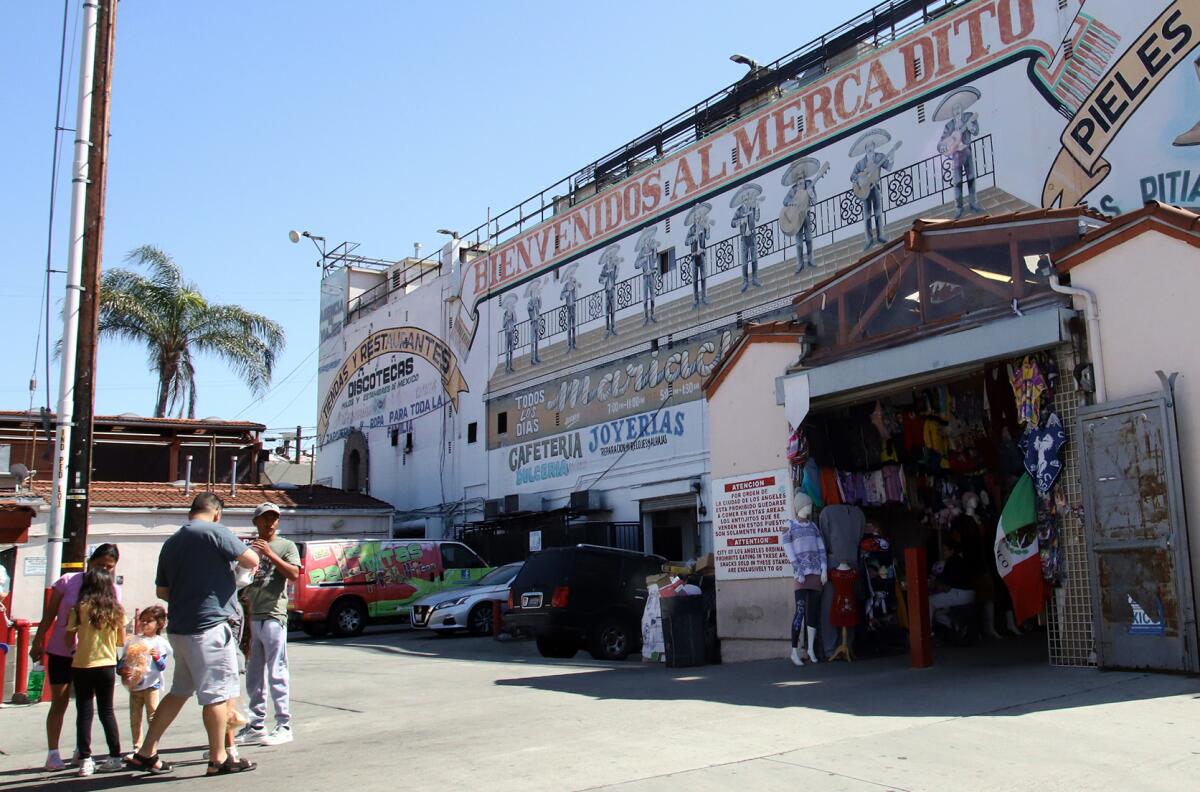 A family shopping outside El Mercadito Mariachi in Los Angeles