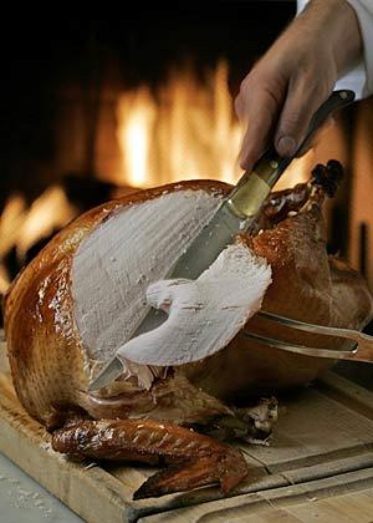 The turkey is gorgeous; go ahead, show it off. Then retreat to the kitchen to carve, allowing yourself the luxury of free bites between slices. -