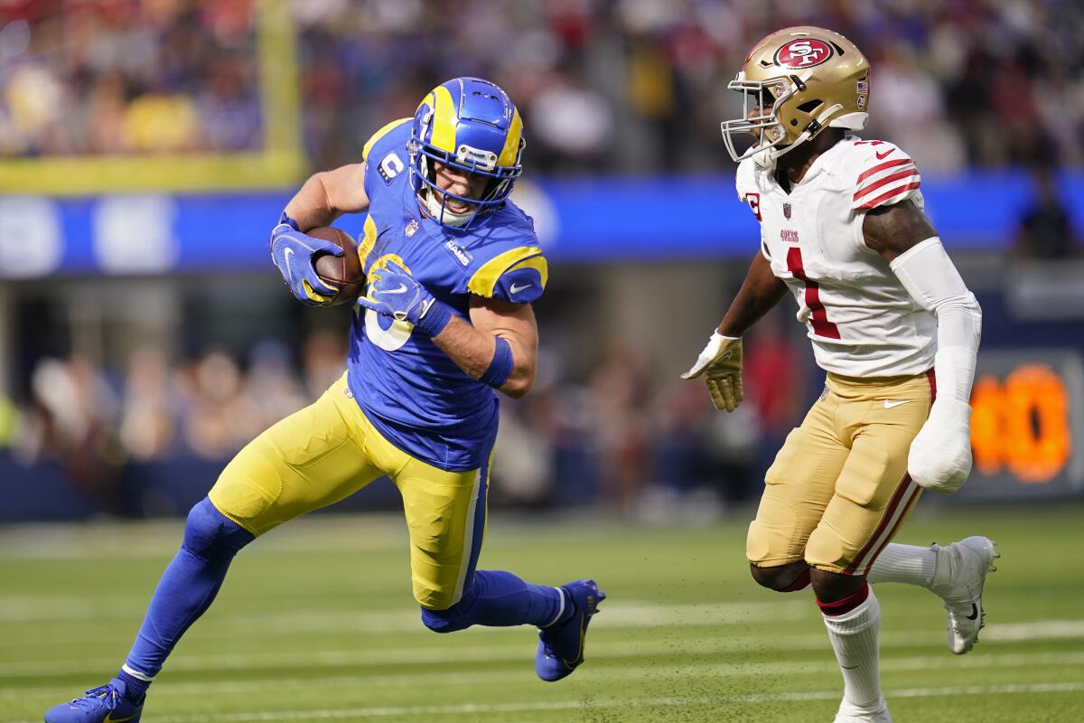 Rams wide receiver Cooper Kupp, left, runs with the ball in front of San Francisco 49ers cornerback Jimmie Ward.
