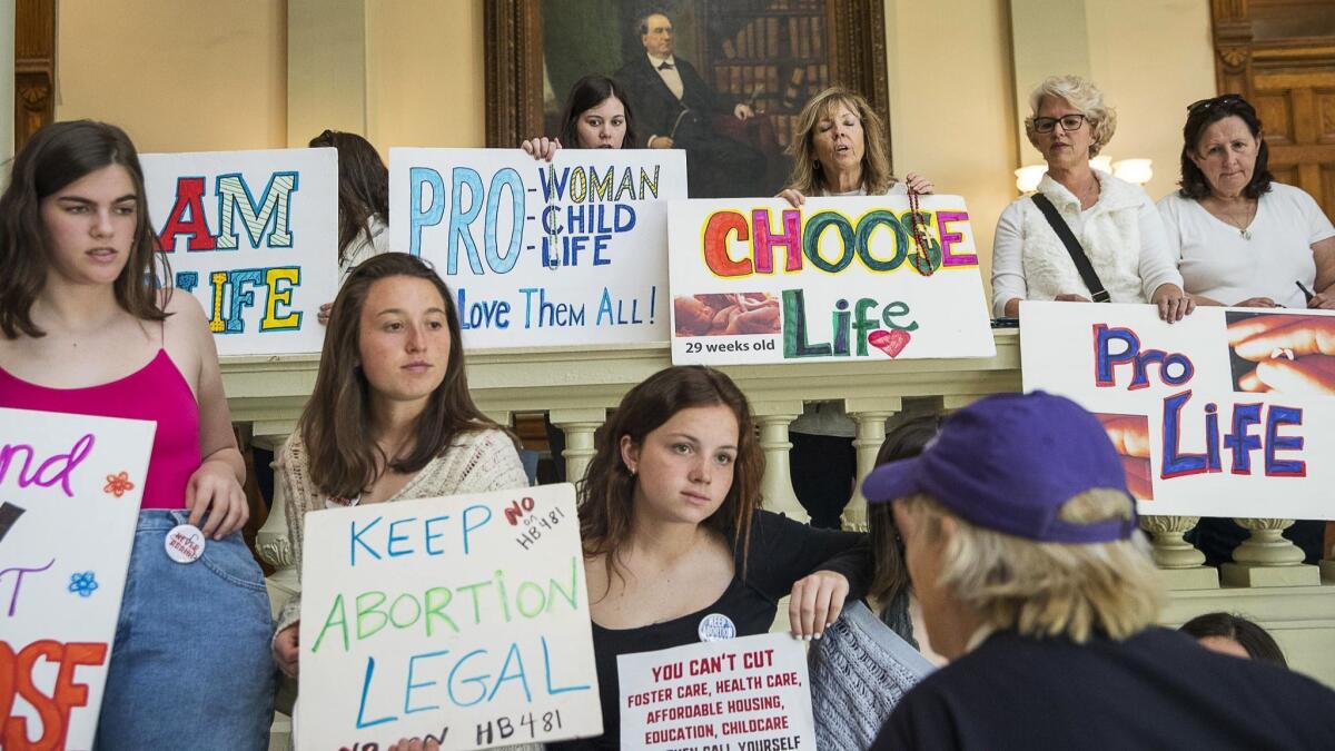 Demonstrators in the lobby of the Georgia State Capitol building in March. Georgia Gov. Brian Kemp signed legislation on Tuesday banning abortions at around six weeks of pregnancy.