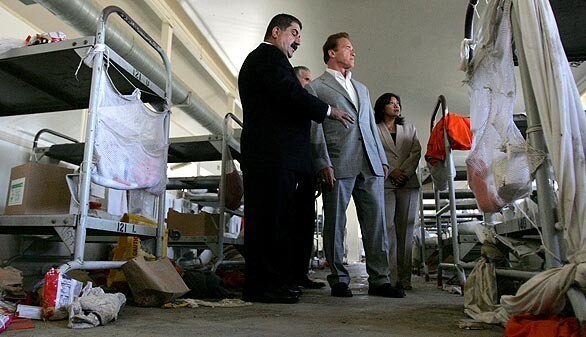 Acting warden Aref Fakhoury, left, talks about the riot as California Gov. Arnold Schwarzenegger and Assemblywoman Norma Torres (D-Pomona) tour the Mariposa residential hall.