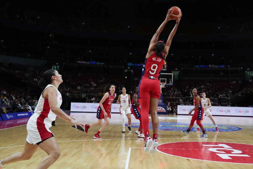 United States' A'ja Wilson reaches up to intercept the ball during their semifinal game at the women's Basketball World Cup against Canada in Sydney, Australia, Friday, Sept. 30, 2022. (AP Photo/Mark Baker)