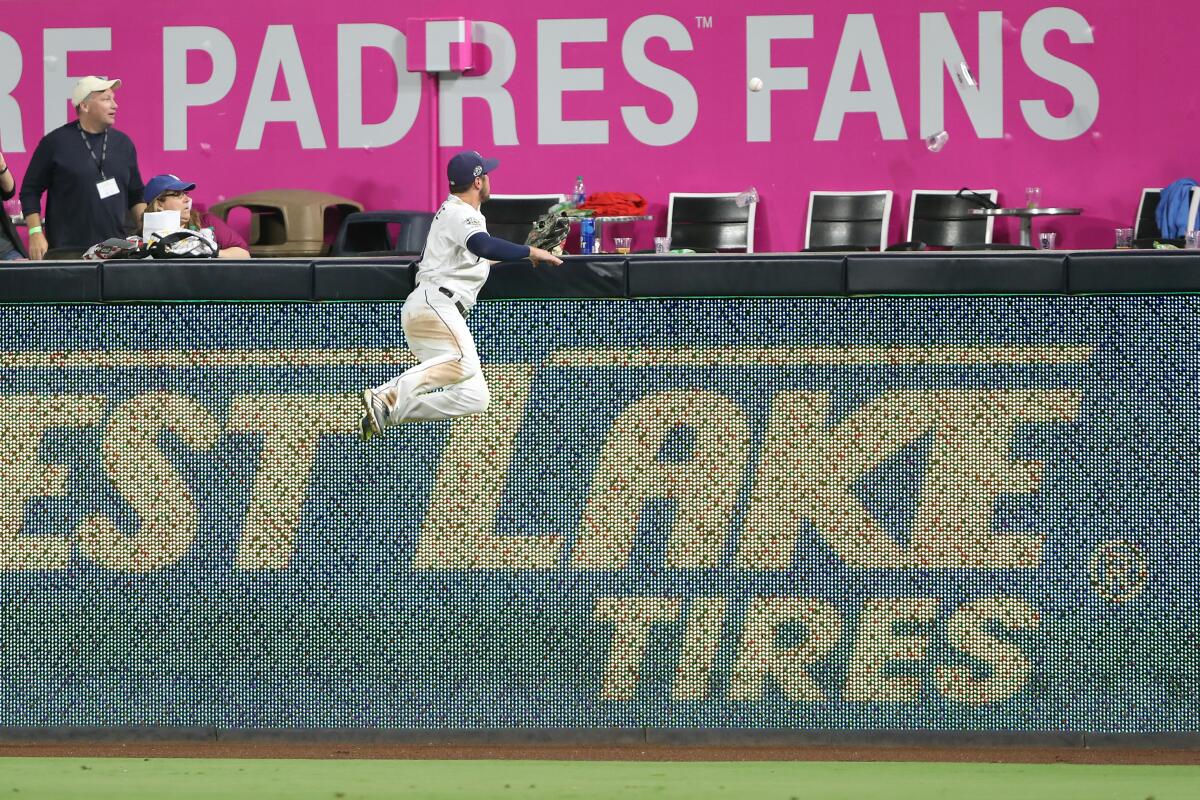 Padres right fielder Hunter Renfroe watches a solo home run hit by the Dodgers' A.J. Pollock sail over the fence during the ninth inning.