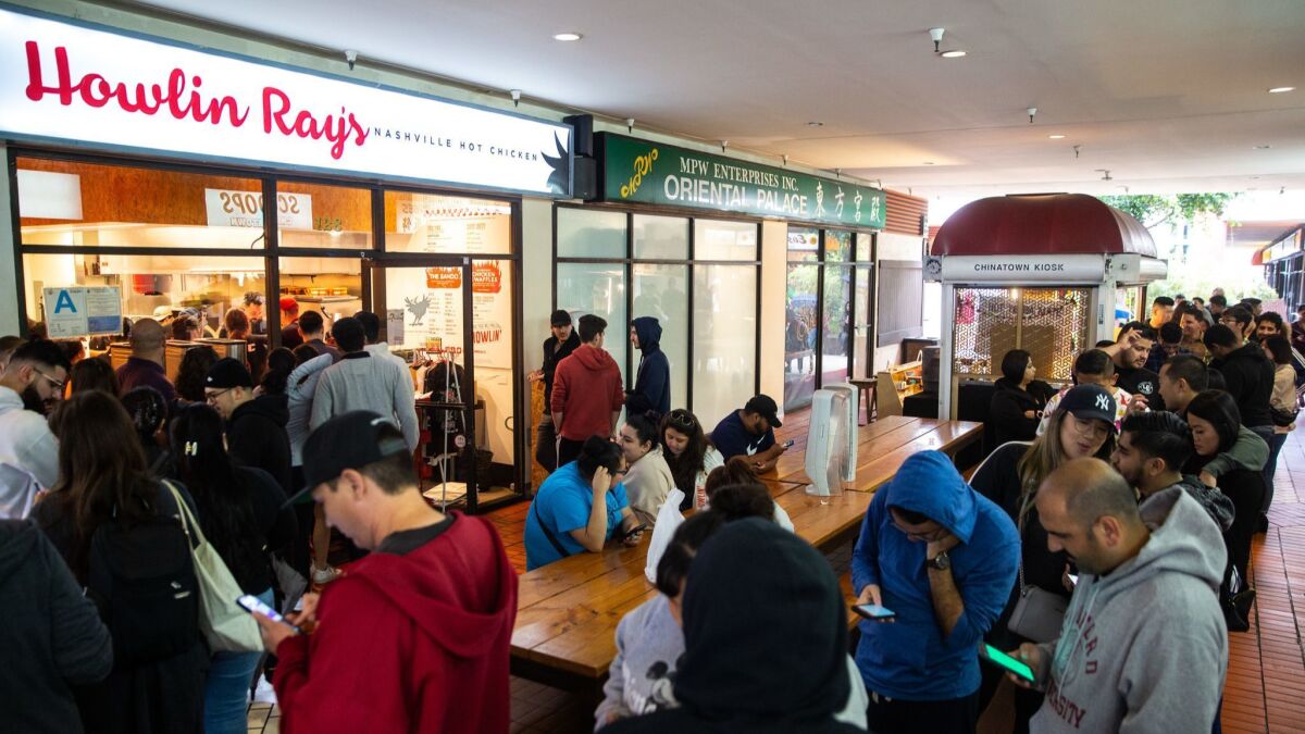 People wait in line for chicken at Howlin' Ray's at Far East Plaza in Chinatown on Thursday.