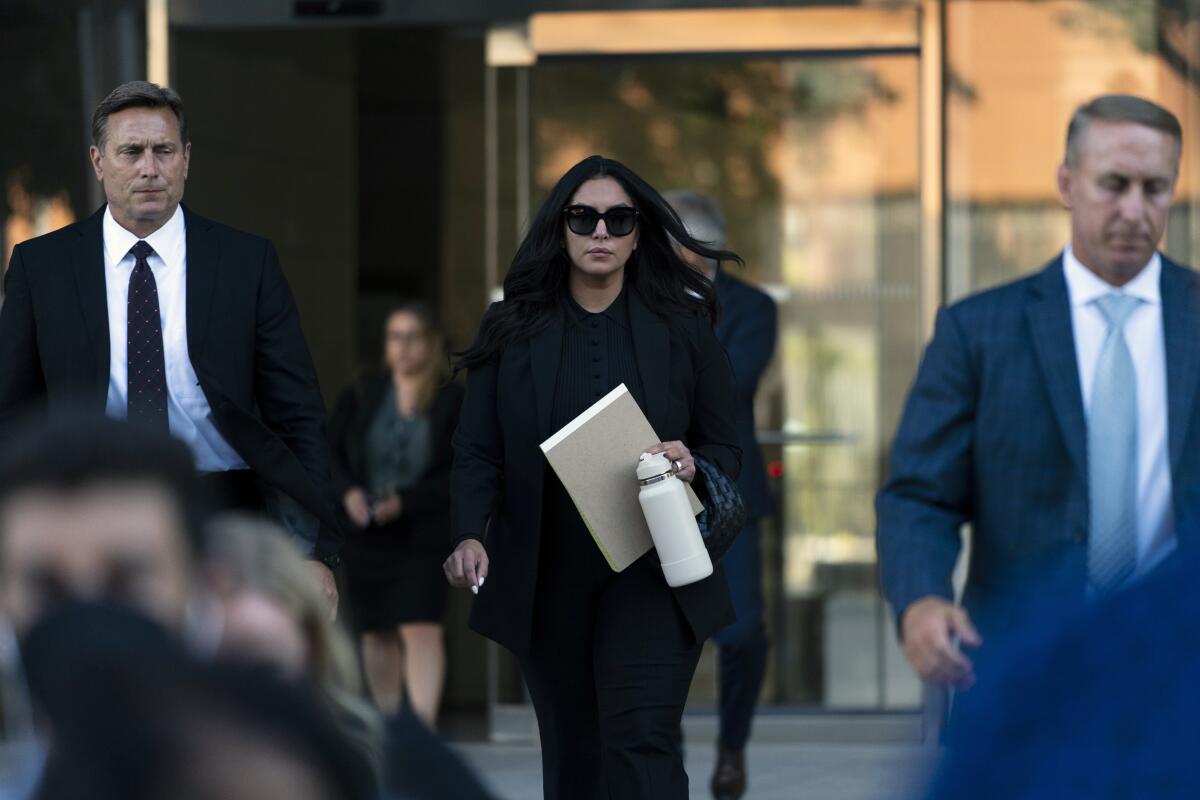 Vanessa Bryant, center, the widow of Kobe Bryant, leaves a federal courthouse in Los Angeles.
