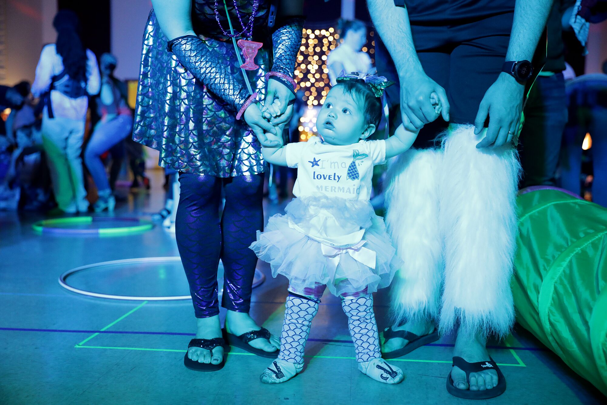 Ariel Harenburg and parents Carolyn Thamkul and Bryce Harenburg get into the club spirit at Baby Rave.