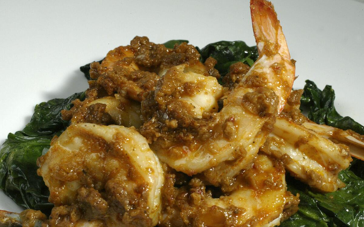 Shrimp in romesco with wilted spinach