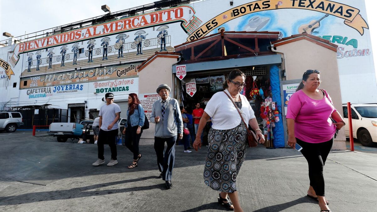 Shoppers exit the El Mercado shopping center in Boyle Heights. A City Council committee has rejected a nonprofit developer's plan to build housing for the homeless nearby.