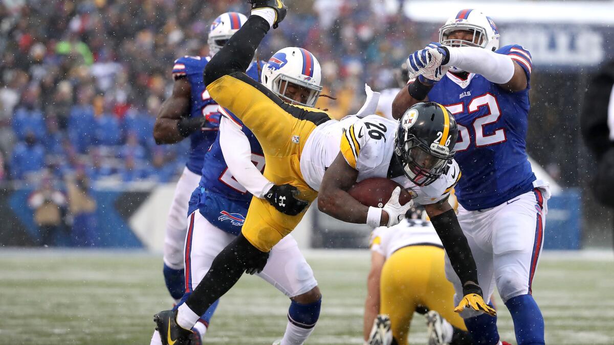 Steelers running back Le'Veon Bell, leaping for extra yards during the second half, set a club record with 236 yards rushing Sunday.