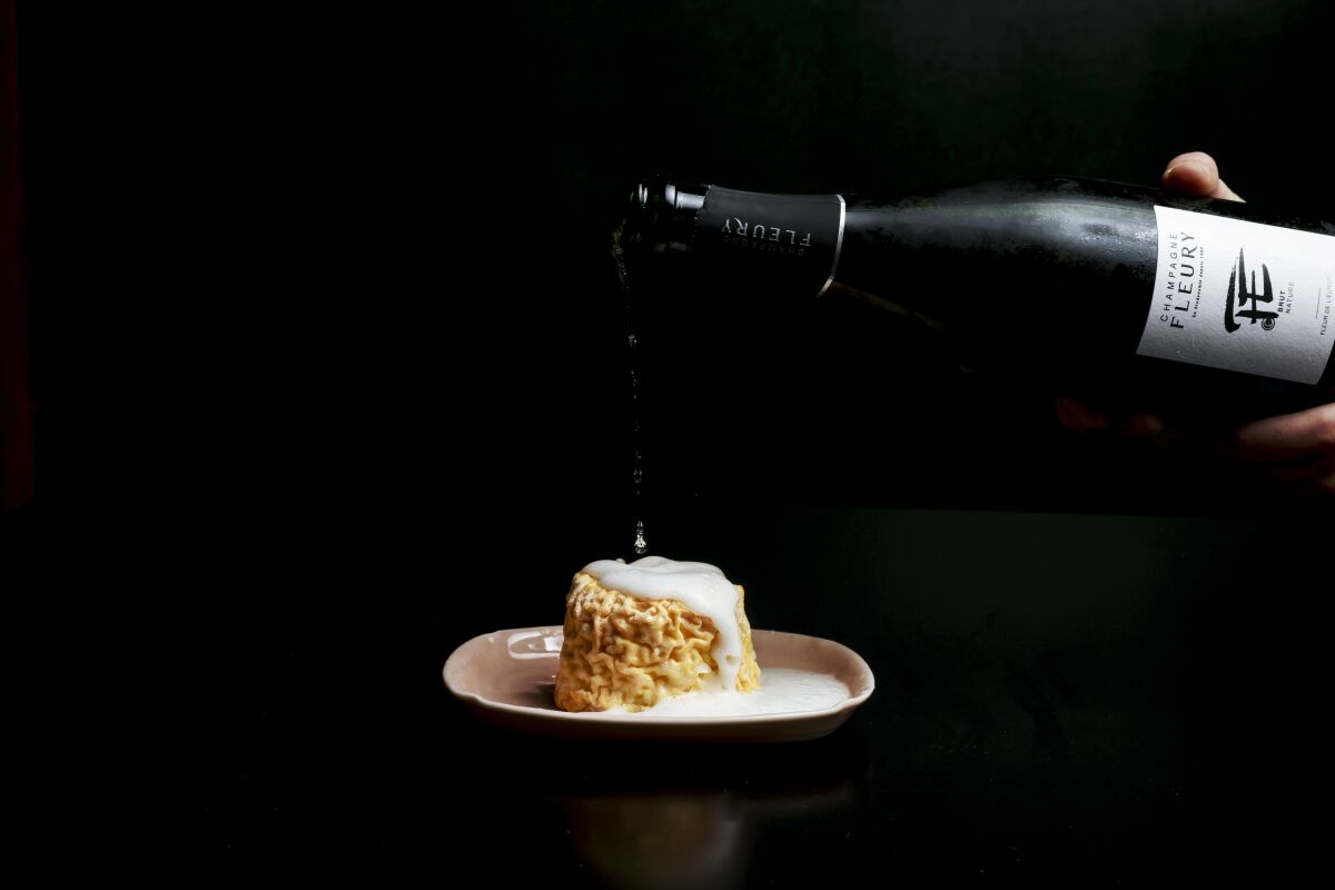Champagne is poured over Langres cheese.