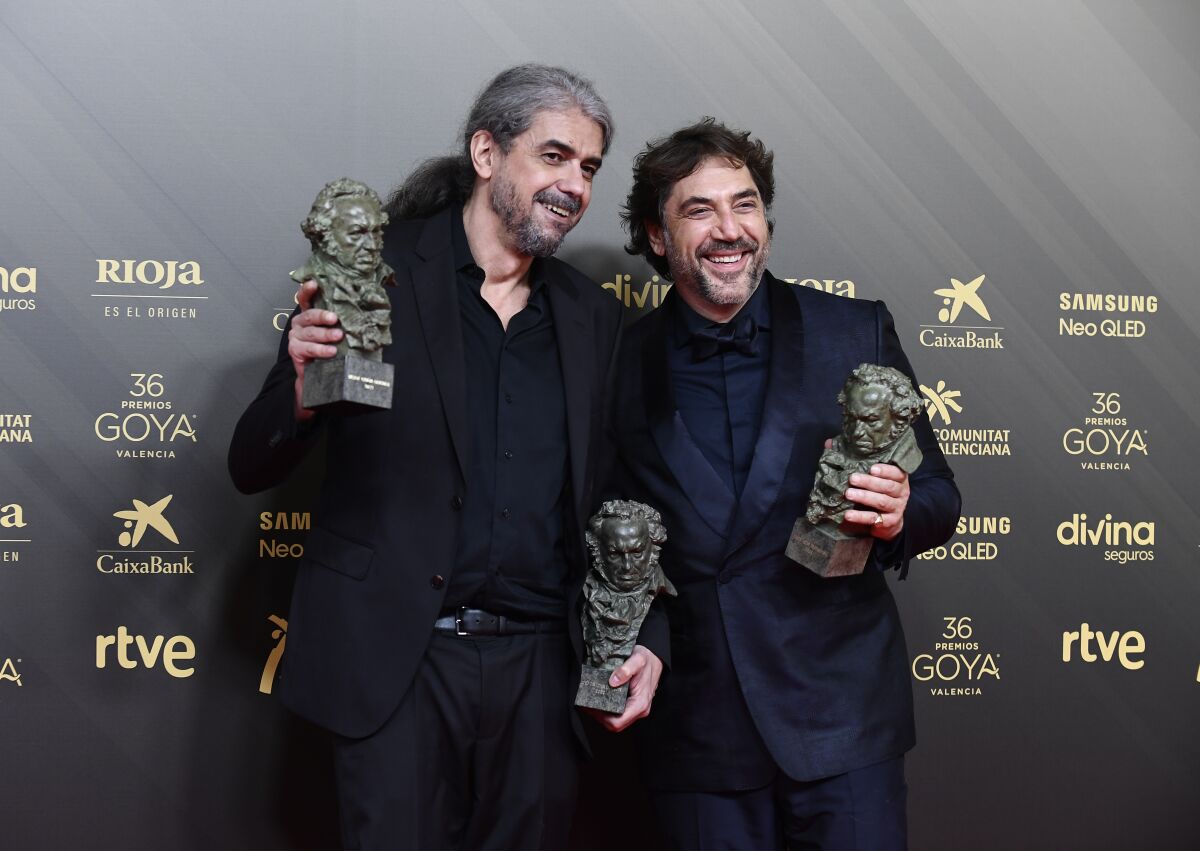 Fernando Leon de Aranoa, left, winner of the awards for best director and best original screenplay for 'El Buen Patron' and Javier Bardem, winner of the award for best actor for 'El Buen Patron' pose in the press room at the 36th Goya Awards Gala on Saturday, February 12, 2022, in Valencia, Spain. (AP Photo/Jose Breton)