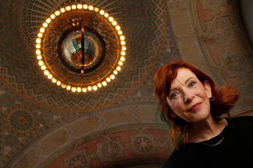 LOS ANGELES, CA-SEPTEMBER 13, 2018: Susan Orlean, who has an upcoming book about the LA Public Library and the mysteries surrounding its devastating 1986 fire, is photographed in the library's 2nd floor rotunda. Above her is the bronze Zodiac Chandelier. (Mel Melcon/Los Angeles Times)