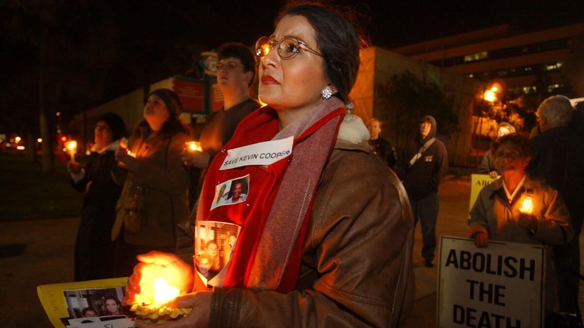 Cindy Stoddard of Palm Desert participates in a candlelight vigil in downtown Riverside on Feb. 3, 2004 in support of condemned killer Kevin Cooper, a week before his scheduled execution.