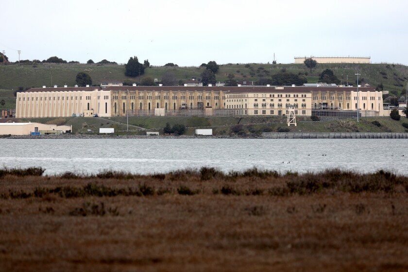 San Quentin State Prison is seen in the distance across a body of water