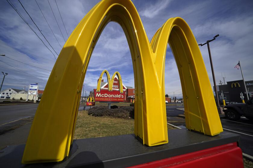 FILE - McDonald's restaurant signs are shown in in East Palestine, Ohio, Feb. 9, 2023. McDonald's reports earning on Monday, July 29, 2024.(AP Photo/Gene J. Puskar, File)