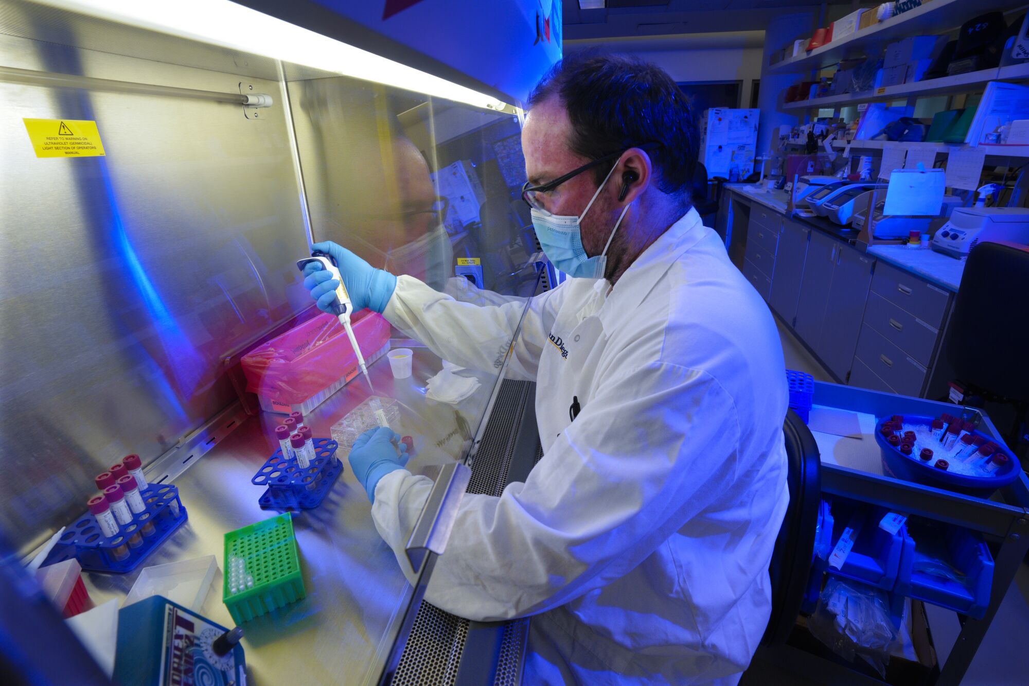 San Diego, CA - December 02: research associate Brendon (cq) Woodworth ran test on swab samples for COVID.
