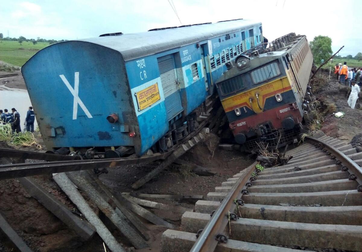 Two passenger trains derailed after being hit by flash floods on a bridge in central India, killing at least 24 people in the latest deadly accident on the nation's crumbling rail network.
