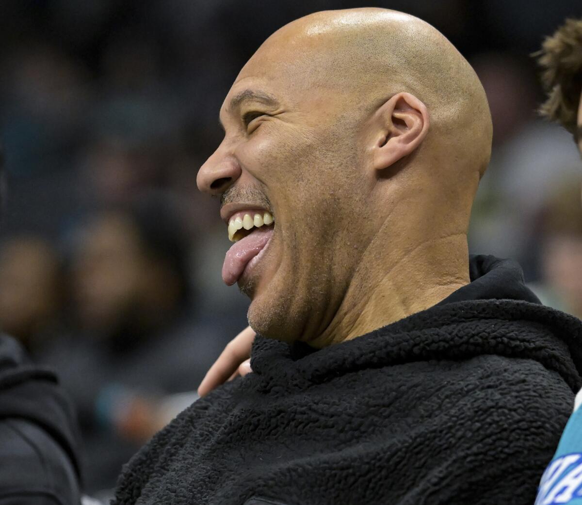 LaVar Ball smiles with his tongue out during a game between the Charlotte Hornets and Indiana Pacers.