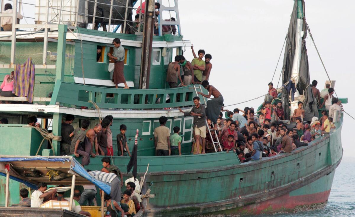 Migrants wait to be rescued by fishermen off East Aceh, Indonesia.