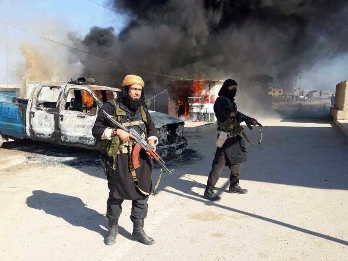This image posted on a militant website, which is consistent with other reporting, shows Shakir Waheib, a senior member of the Islamic State of Iraq and Syria, left, next to a burning police vehicle in Iraq's Anbar Province. Al Qaeda has declared publicly that it has no link to the group known as ISIS, which is waging a brutal guerrilla war in both Iraq and Syria. The Islamic State is "not a branch of Al Qaeda,¿ has no ¿organizational relationship¿ with Al Qaeda, declared a blunt statement issued by Al Qaeda's Pakistan-based central command.