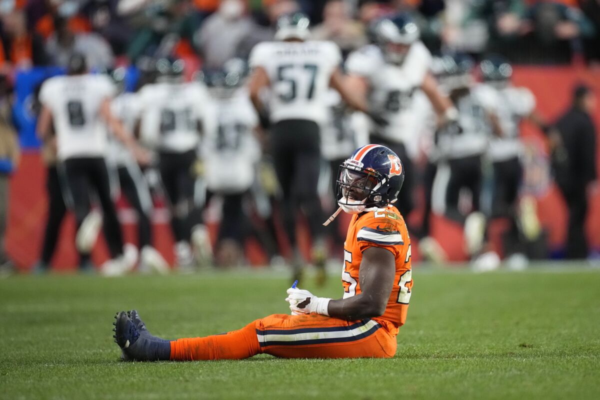 Denver Broncos running back Melvin Gordon (25) sits on the field after fumbling against the Philadelphia Eagles during the second half of an NFL football game, Sunday, Nov. 14, 2021, in Denver. The Eagles scored a touchdown on the fumble recovery. (AP Photo/David Zalubowski)