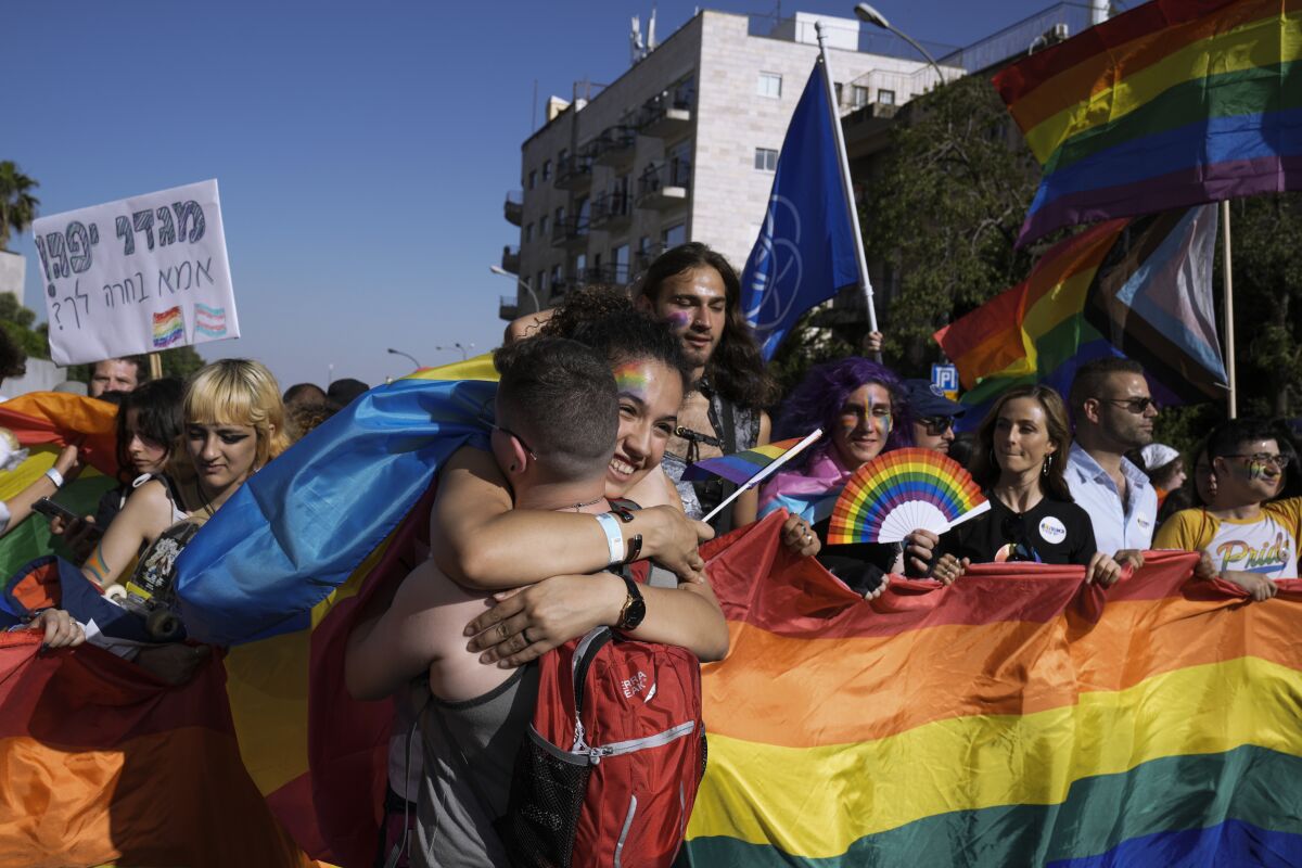 Thousands of people march under heavy security in the annual Pride Parade, in Jerusalem, Thursday, June 2, 2022. Israeli police say they arrested a man on Thursday suspected of sending death threats to an organizer of the annual Jerusalem Pride Parade, an event that has witnessed attacks on participants by religious radicals in previous years. (AP Photo/Maya Alleruzzo)