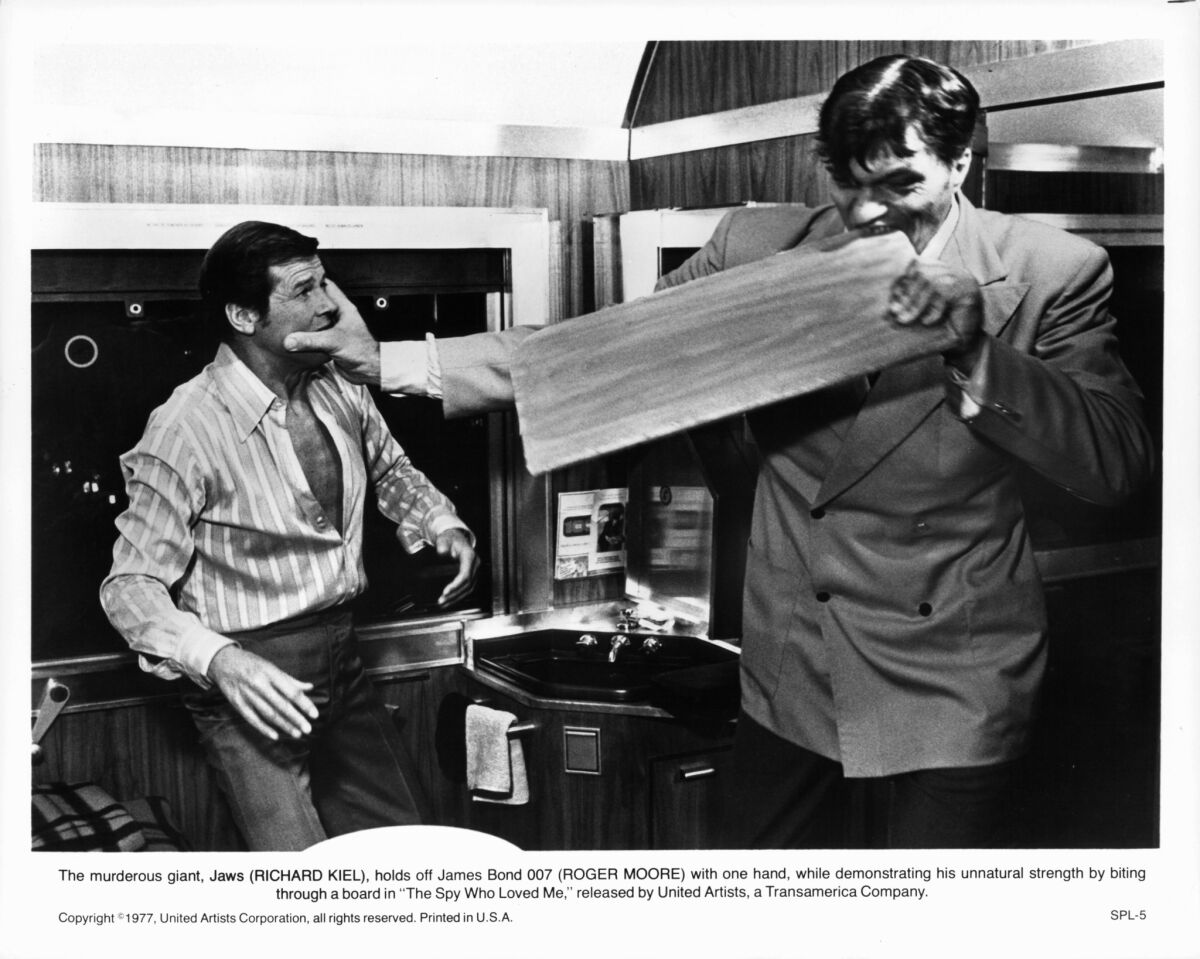Roger Moore fights with Richard Kiel, as Jaws, who bites through a board in a scene from the 1977 film ''The Spy Who Loved Me." Kiel died Wednesday at the age of 74.