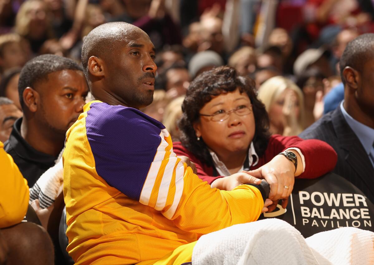 Judy Seto massages Kobe Bryant's wrist.