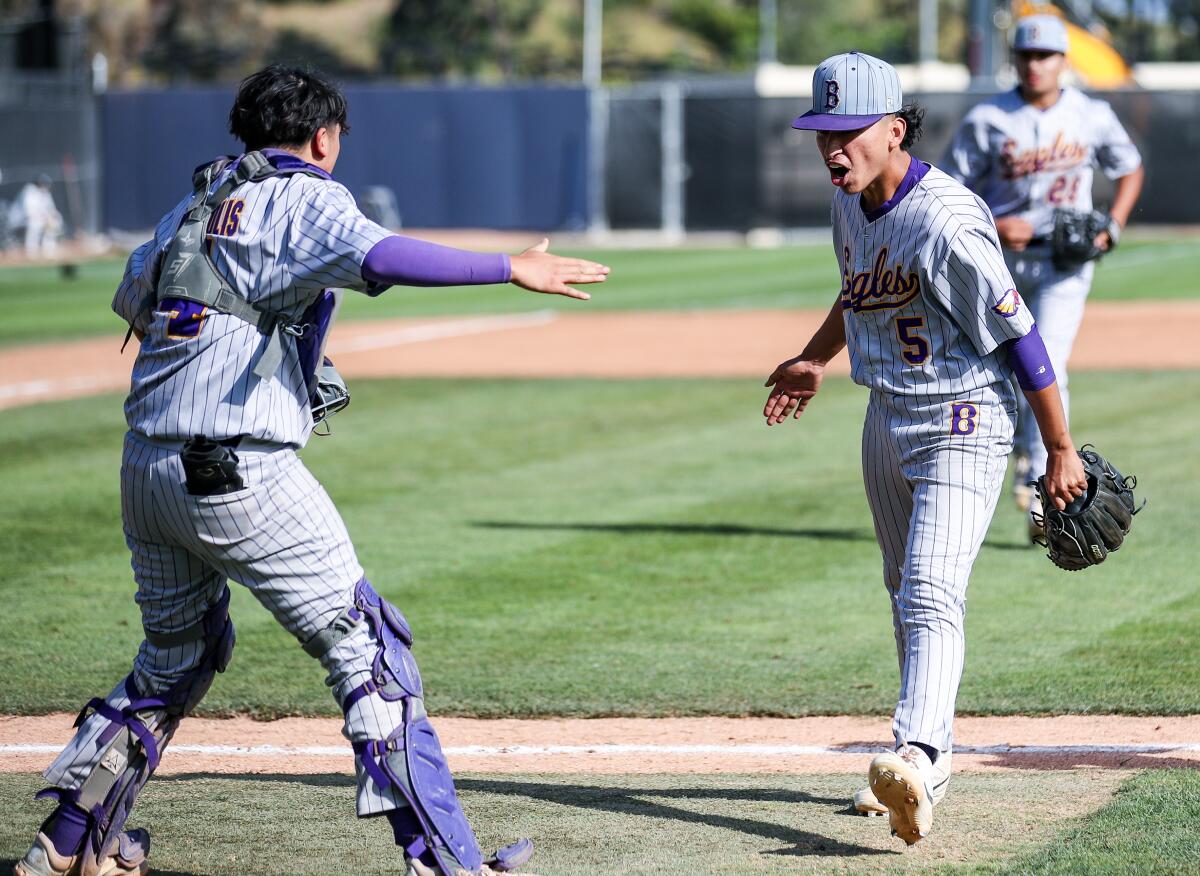 Catcher Nomar Solis prepares to hug pitcher Rigoberto Baltazar after Bell's City Open Division semifinal win.