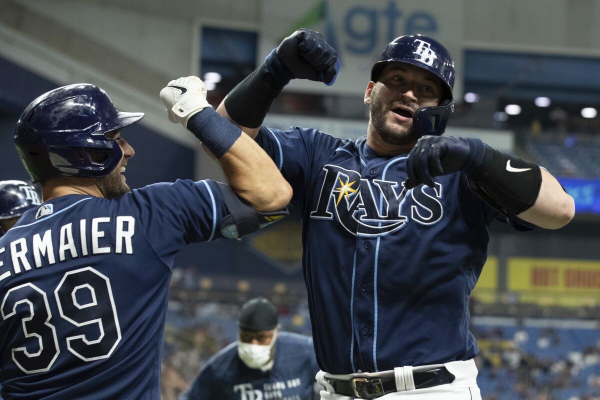Tampa Bay Rays' Mike Zunino, right, celebrates with Kevin Kiermaier after hitting a two-run home run against the Detroit Tigers during the sixth inning of a baseball game Thursday, Sept. 16, 2021, in St. Petersburg, Fla. (AP Photo/Scott Audette)