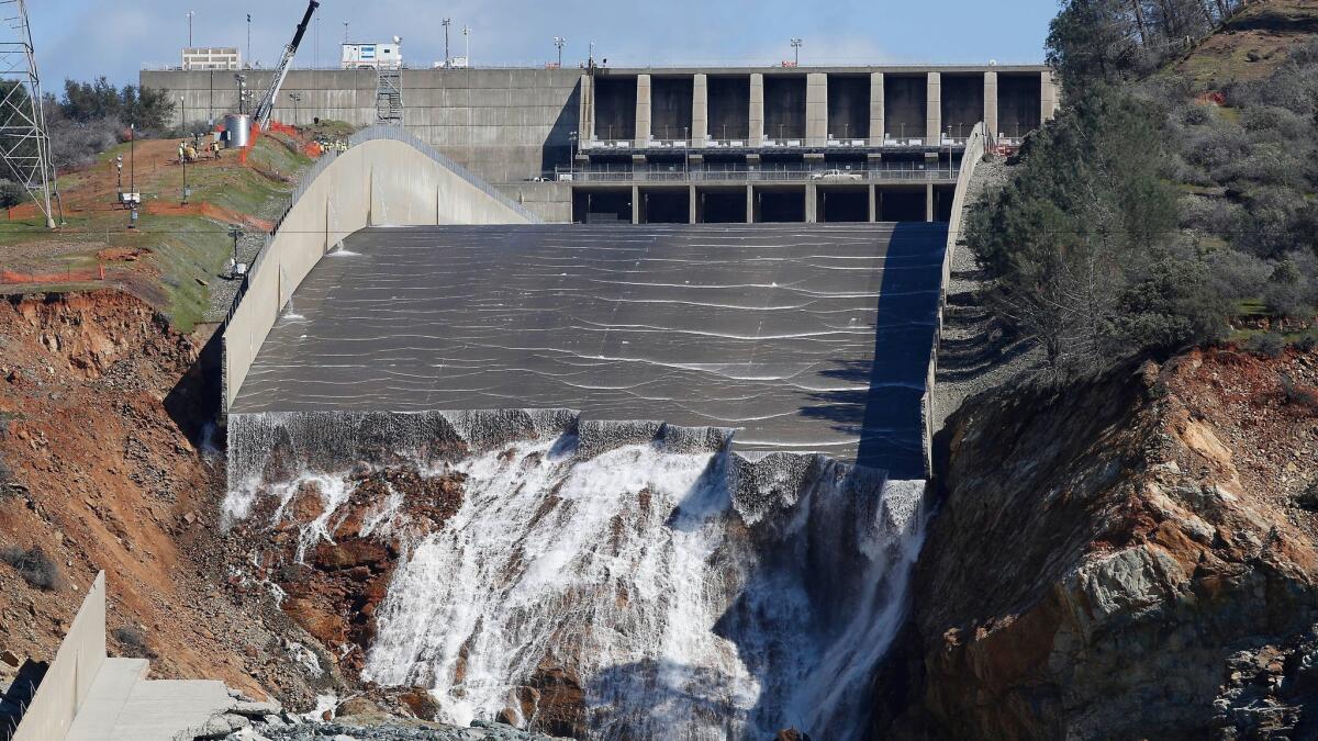 Officials inspect Oroville Dam's crippled main spillway in February.