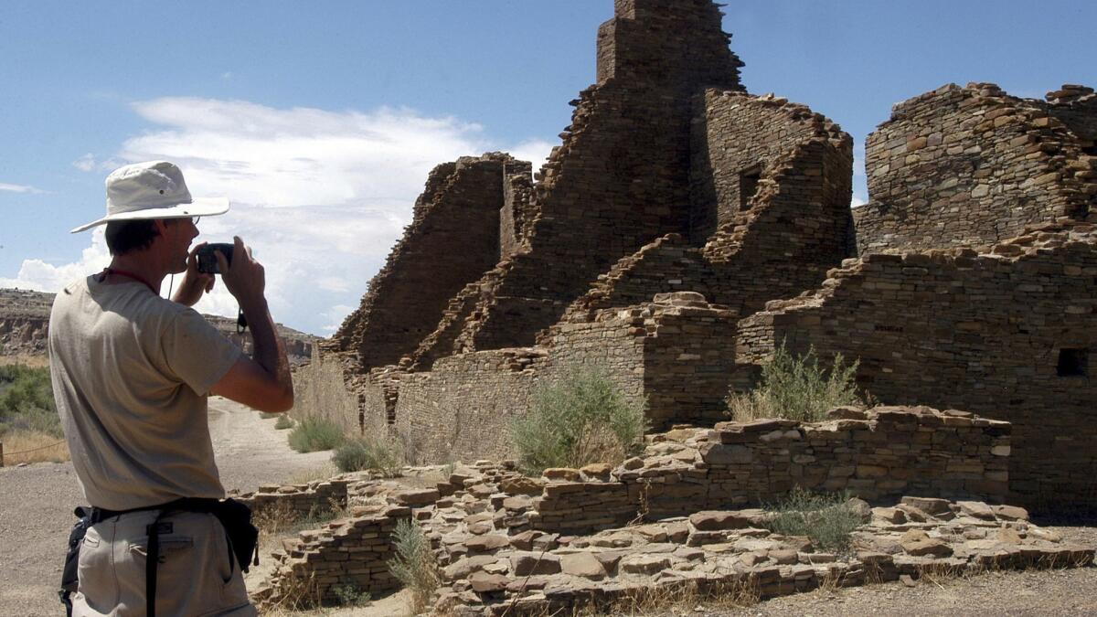 Tourist takes a picture while visiting Chaco Culture National Historical Park in northwestern New Mexico.