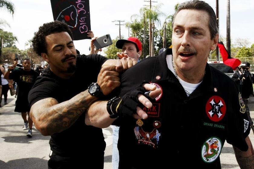 William Hagen, right, shown at a Ku Klux Klan rally in Anaheim, was arrested and charged with assault with intent to kill in North Carolina. Hagen is a high-ranking Klansman based in California.